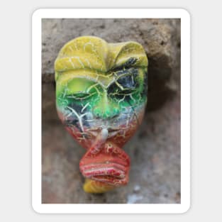 A Bali face mask with finger on its mouth. Sticker